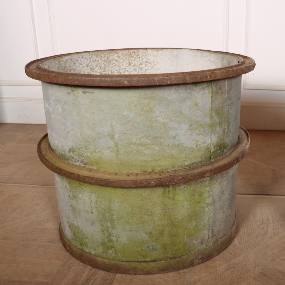 A pair of cylindrical weathered zinc planters featuring rusty iron rims and mid-bands with a distressed aged finish. View II