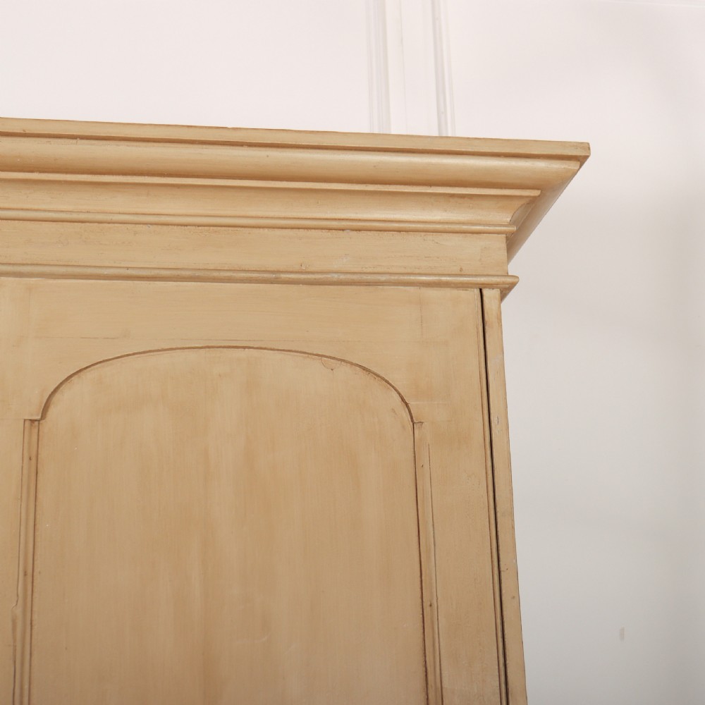 A large two-part painted pine housekeepers cupboard featuring three upper arched-panel doors above three central drawers flanked by side cupboards. View II