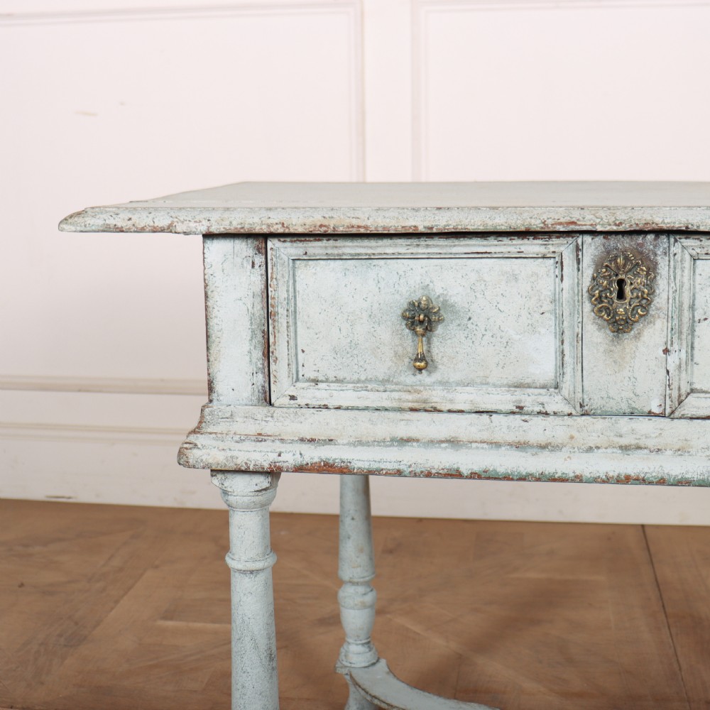 An 18th-century painted wooden side table featuring a pale blue distressed surface, turned legs, an X-frame stretcher, and two drawer fronts with brass pulls. View III