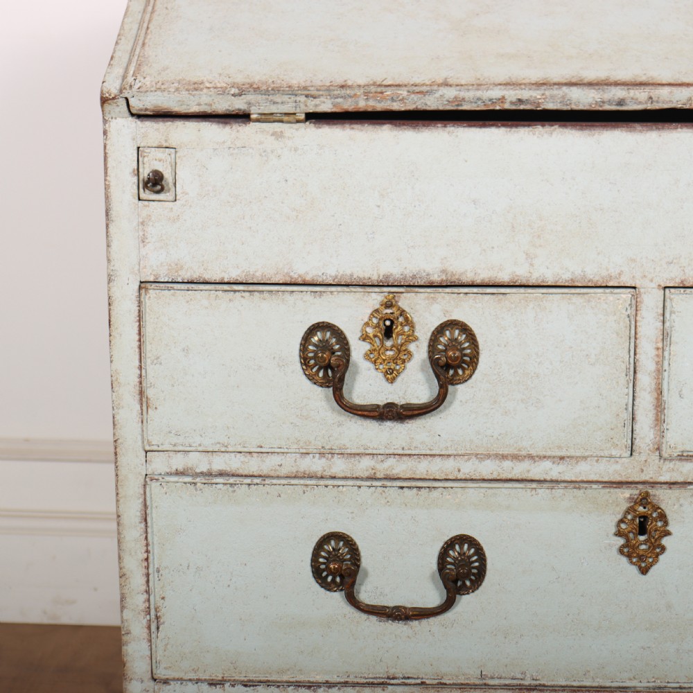 An 18th-century slant-front writing bureau with a distressed off-white painted finish, brass drop handles, and bracket feet. View II