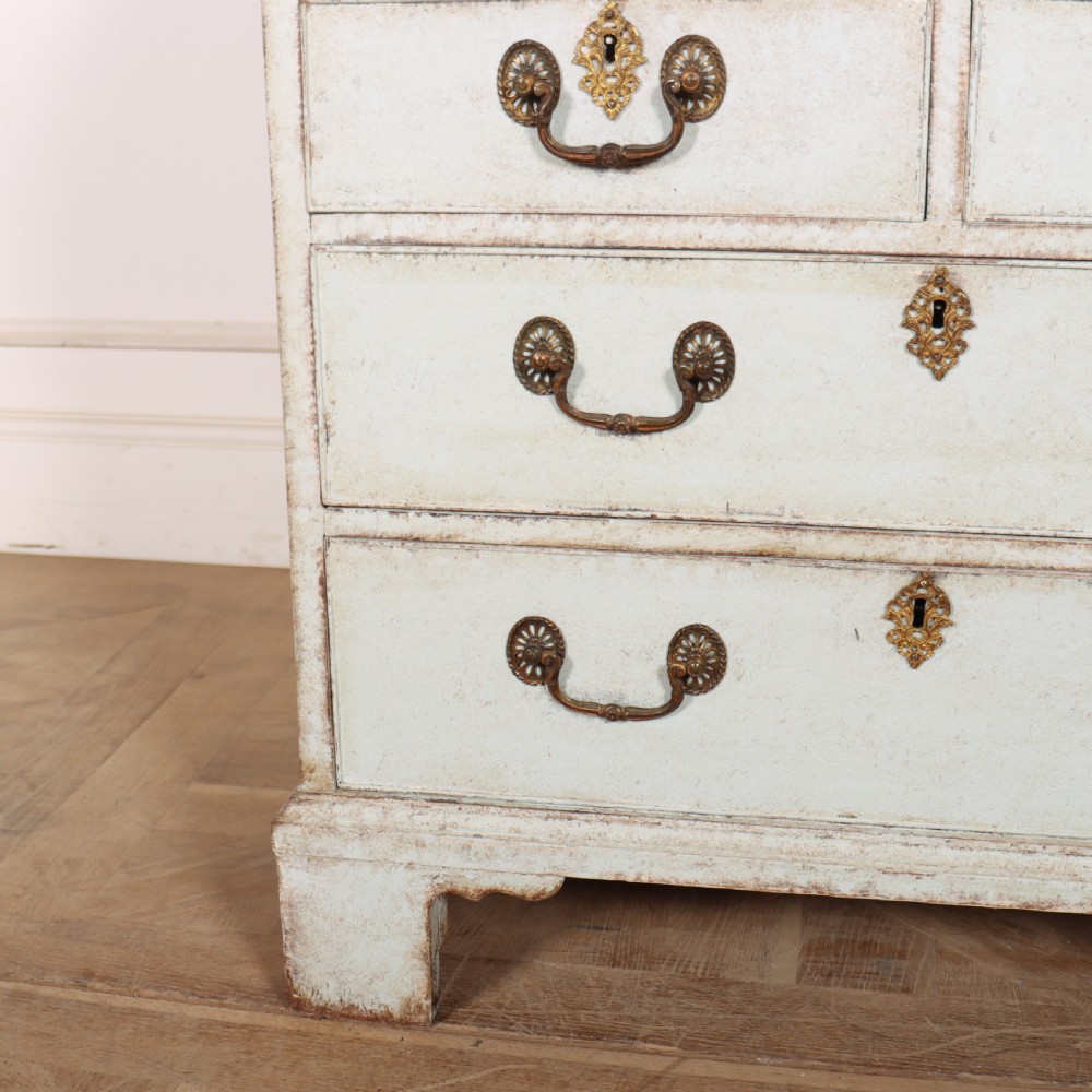 An 18th-century slant-front writing bureau with a distressed off-white painted finish, brass drop handles, and bracket feet. View III