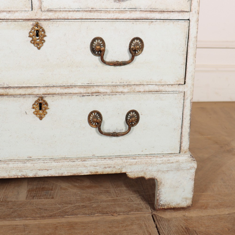 An 18th-century slant-front writing bureau with a distressed off-white painted finish, brass drop handles, and bracket feet. View IV