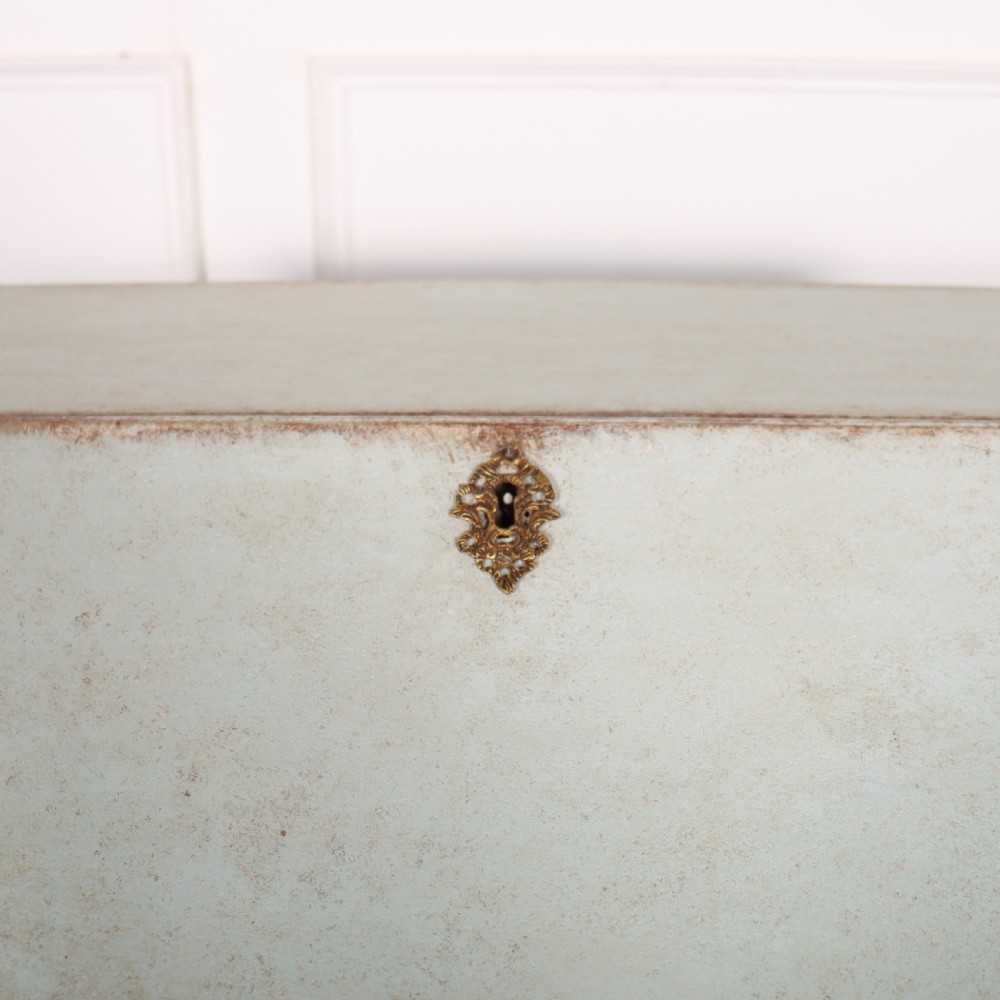An 18th-century slant-front writing bureau with a distressed off-white painted finish, brass drop handles, and bracket feet. View VI
