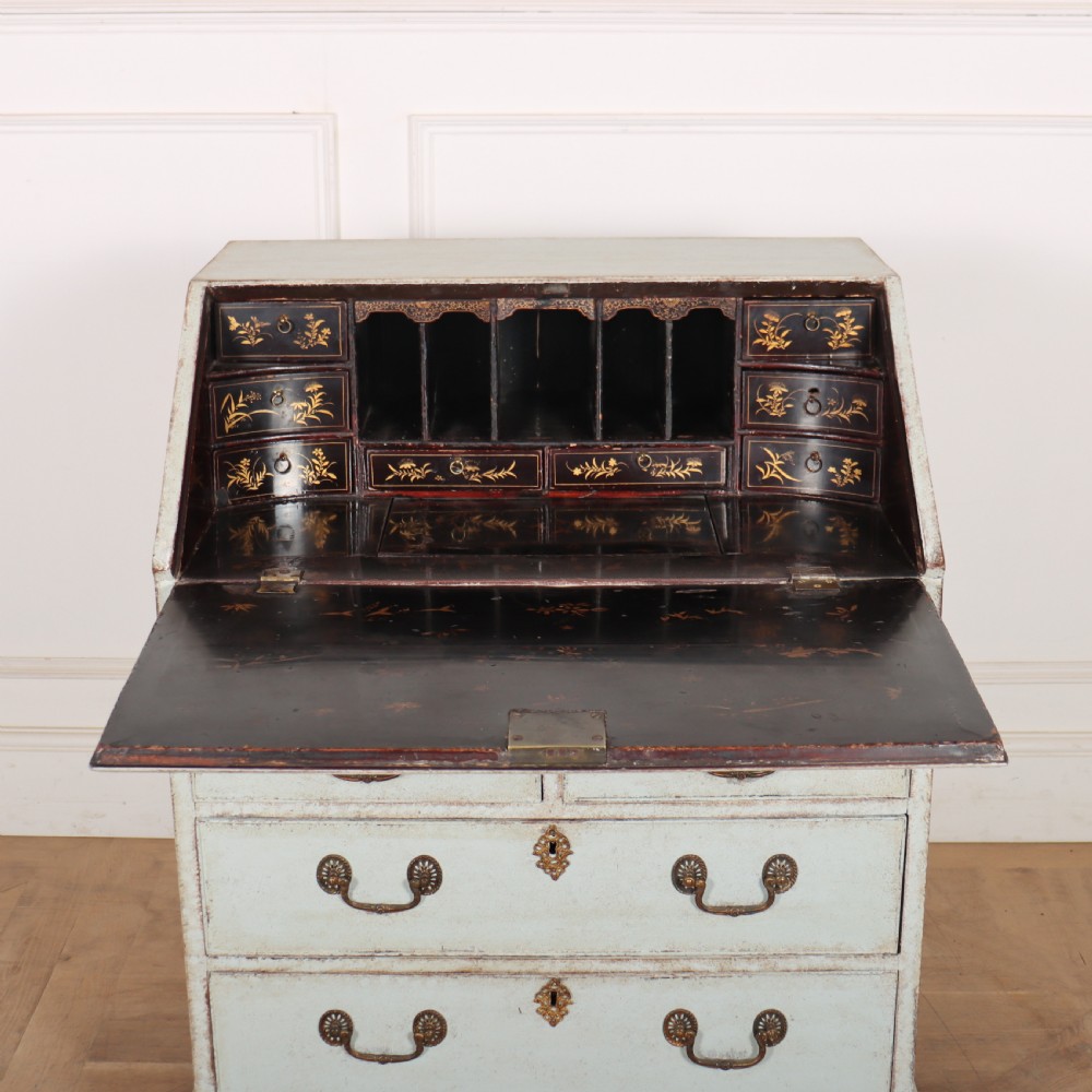 An 18th-century slant-front writing bureau with a distressed off-white painted finish, brass drop handles, and bracket feet. View VII