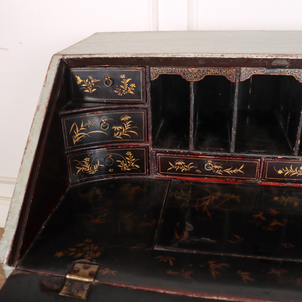 An 18th-century slant-front writing bureau with a distressed off-white painted finish, brass drop handles, and bracket feet. View VIII