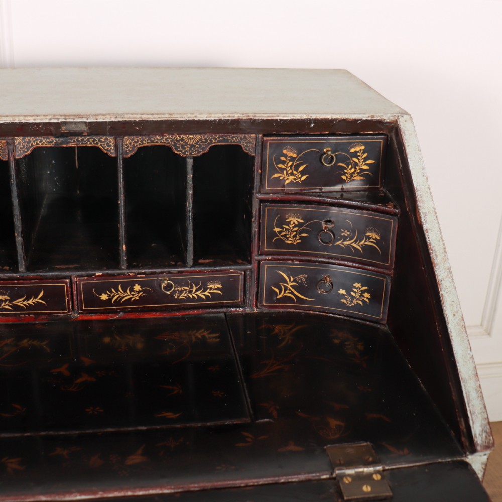 An 18th-century slant-front writing bureau with a distressed off-white painted finish, brass drop handles, and bracket feet. View IX