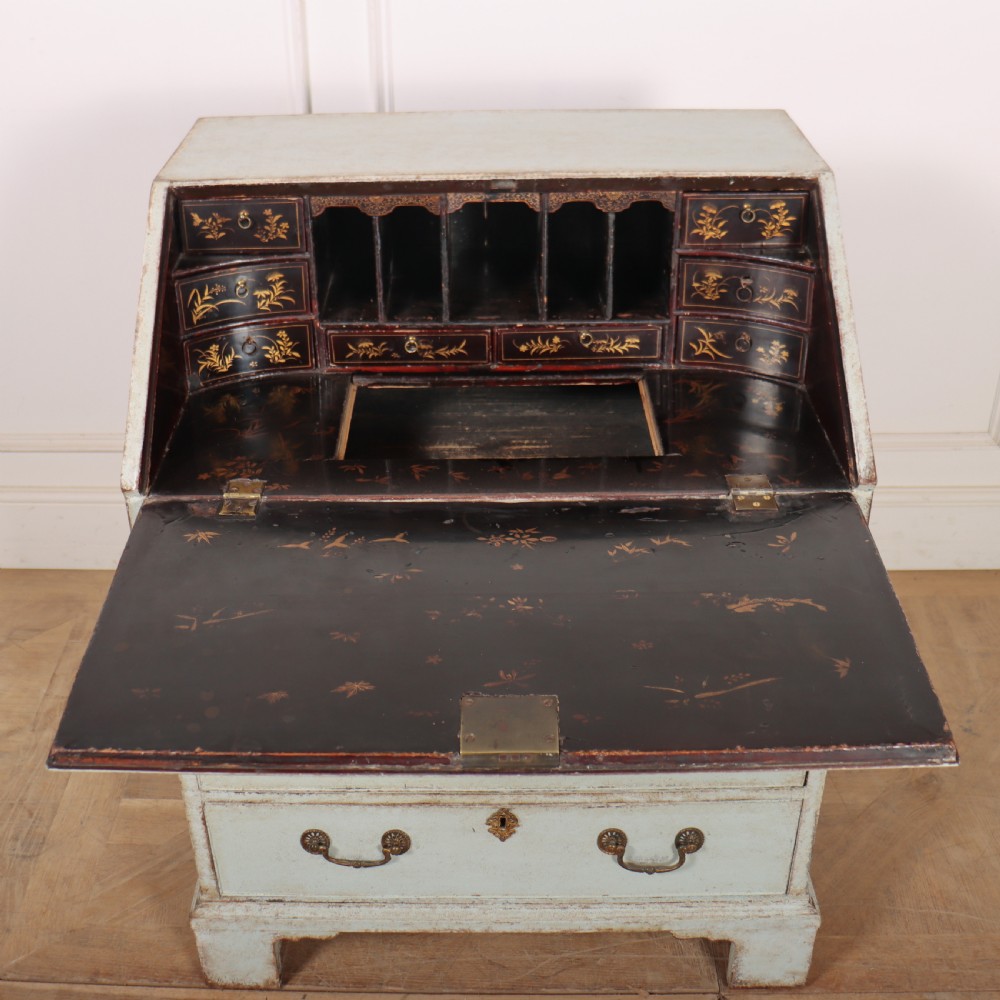 An 18th-century slant-front writing bureau with a distressed off-white painted finish, brass drop handles, and bracket feet. View XI