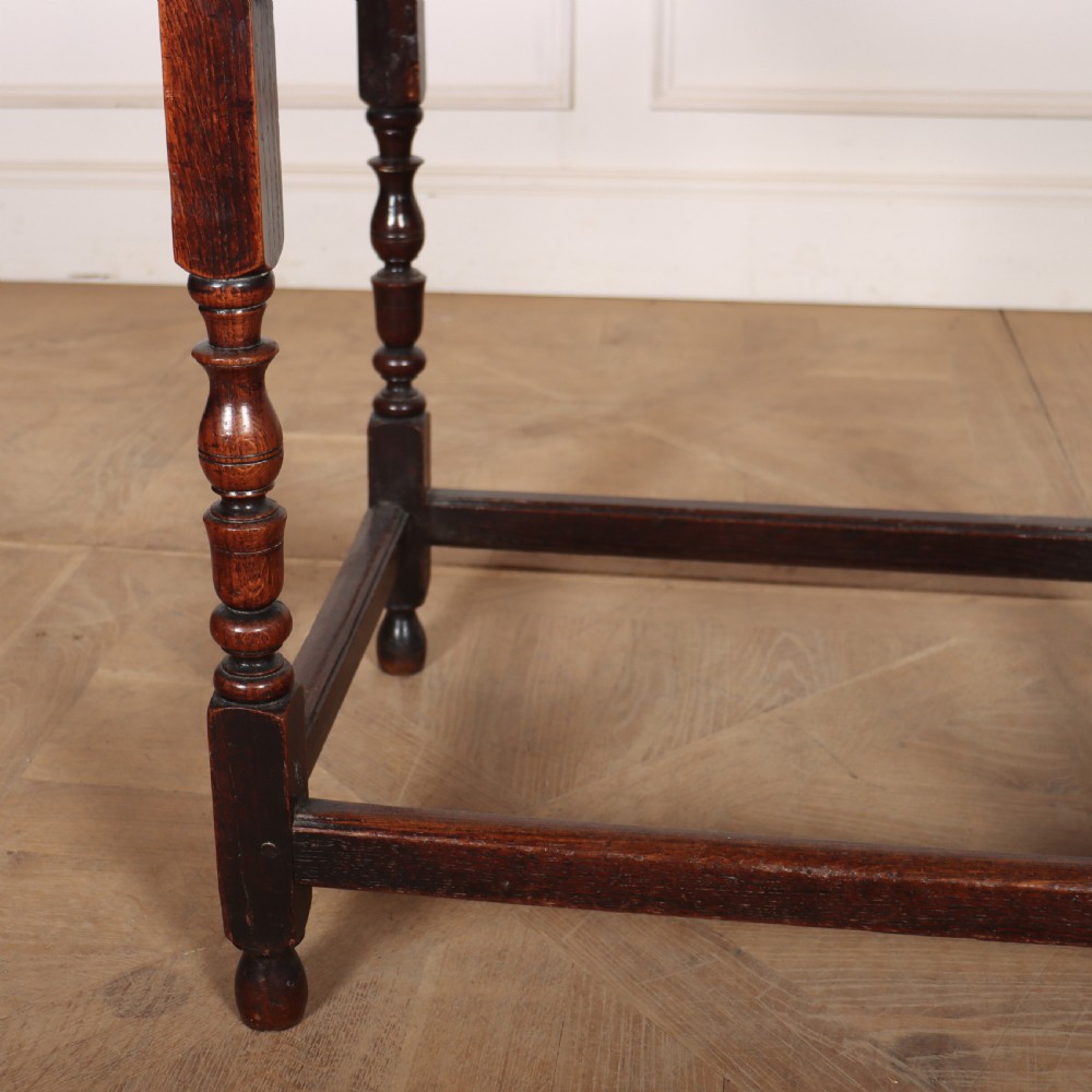 A dark oak 17th-century lamp table featuring a single drawer with a teardrop brass handle, turned baluster legs, and lower box stretchers. View II