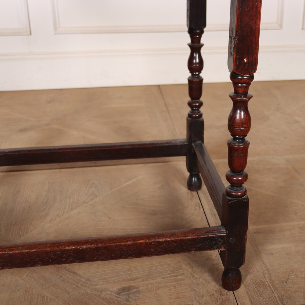 A dark oak 17th-century lamp table featuring a single drawer with a teardrop brass handle, turned baluster legs, and lower box stretchers. View III
