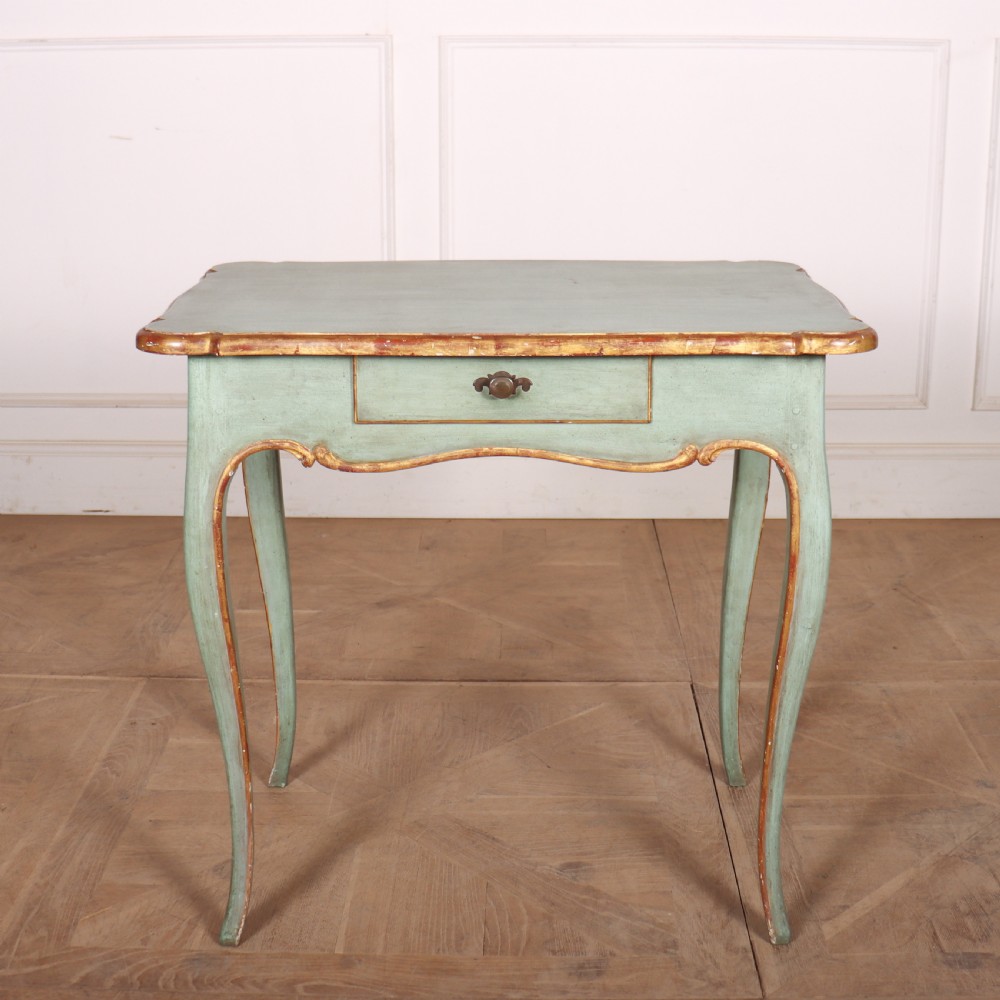 A sage green painted wooden side table featuring gilt trim, a serpentine edge, a single drawer, and four slender cabriole legs.