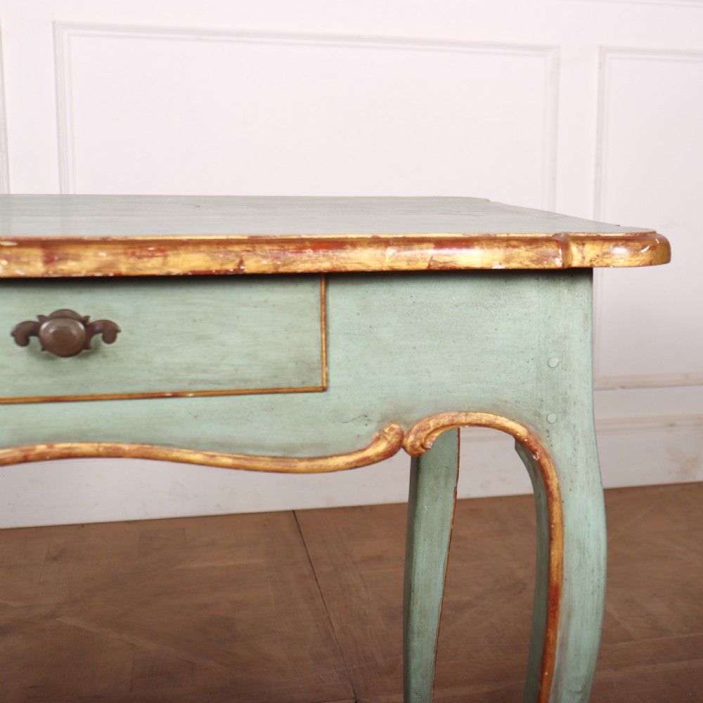 A sage green painted wooden side table featuring gilt trim, a serpentine edge, a single drawer, and four slender cabriole legs. View IV