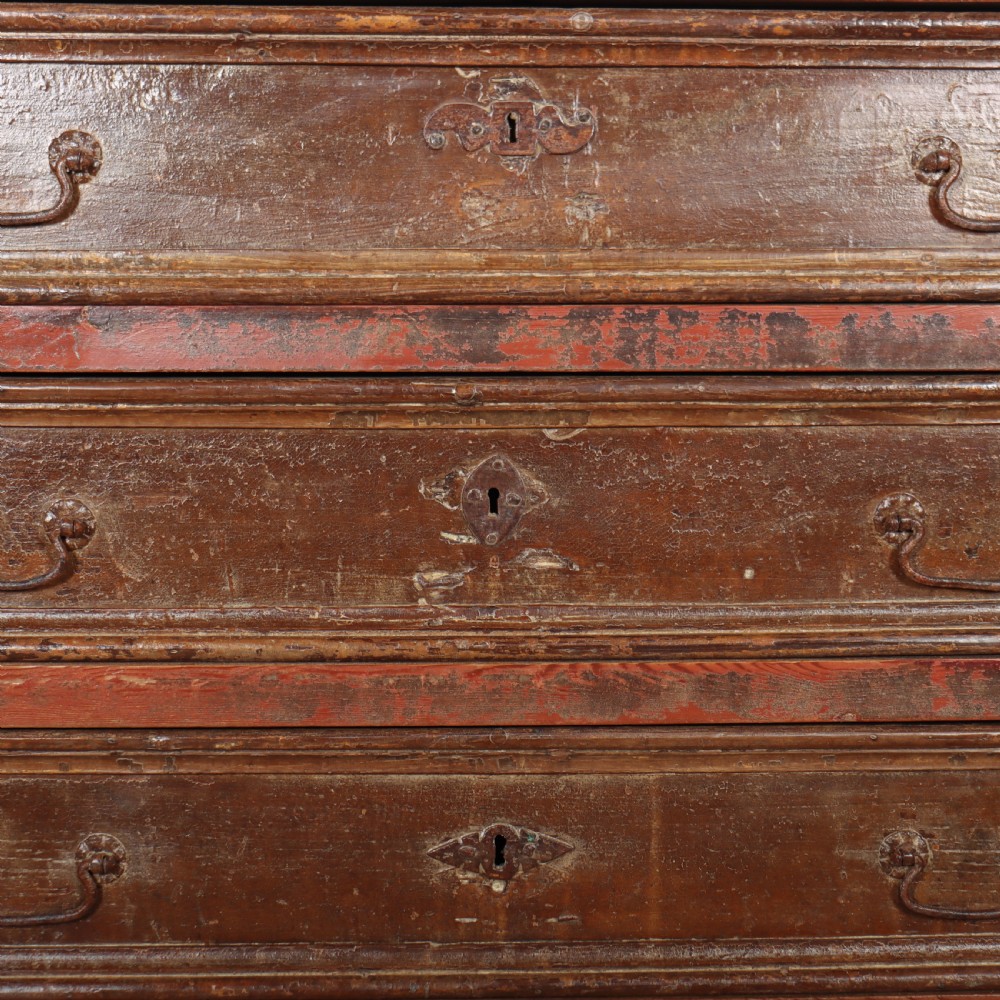 An antique three-drawer Italian commode featuring a painted red and brown finish, carved cabriole legs, and metal drop handles. View X