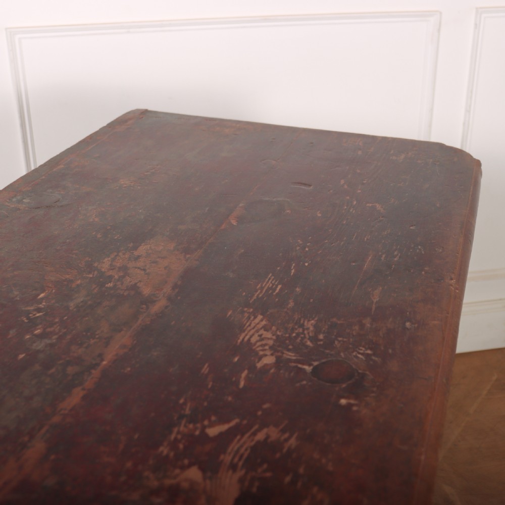 An antique three-drawer Italian commode featuring a painted red and brown finish, carved cabriole legs, and metal drop handles. View XI