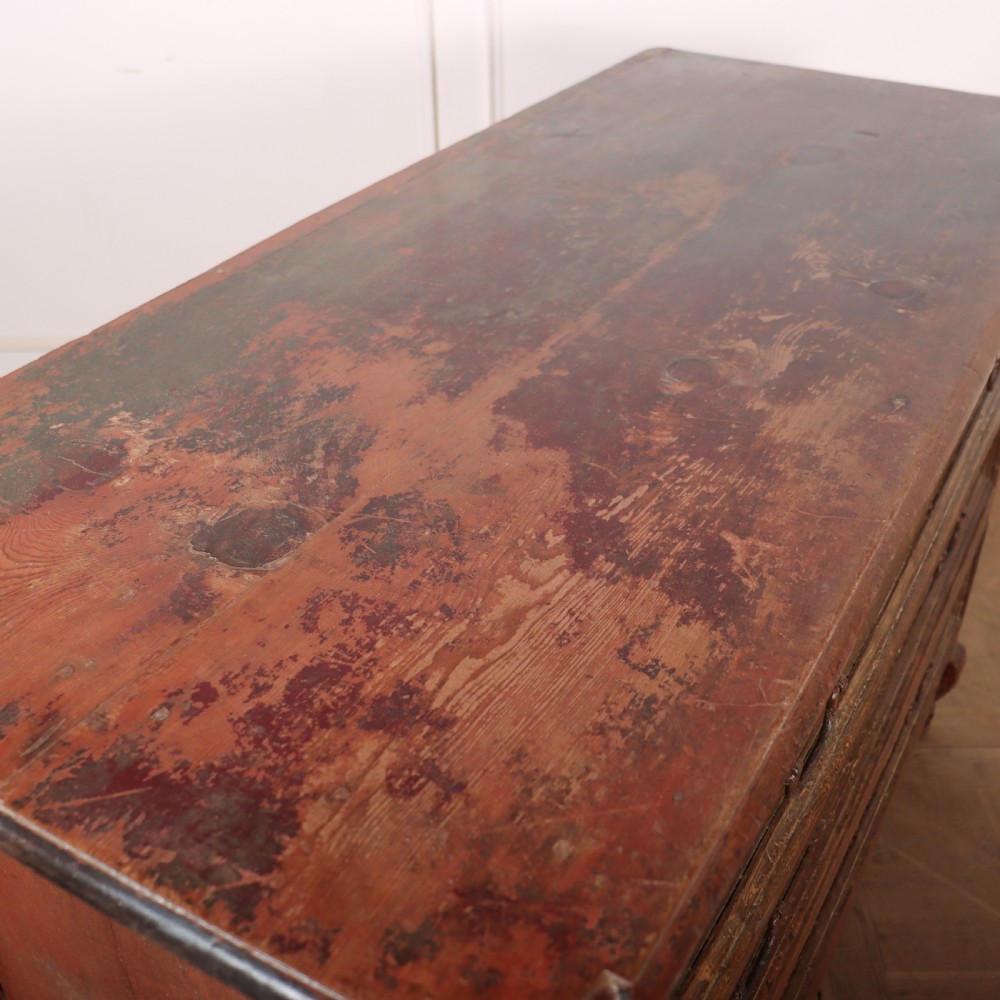 An antique three-drawer Italian commode featuring a painted red and brown finish, carved cabriole legs, and metal drop handles. View XII