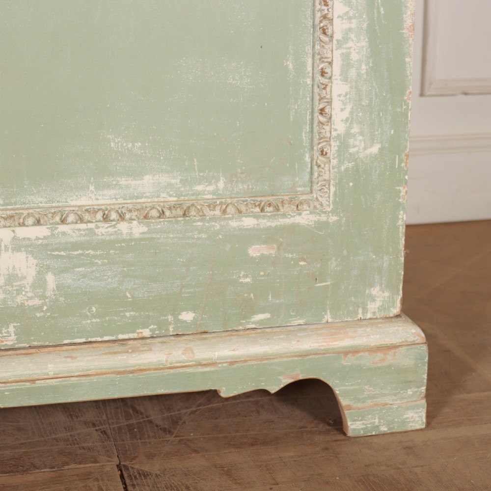 A 19th-century green painted wooden wardrobe featuring an arched carved cresting, double panelled doors, and a distressed finish. View VII