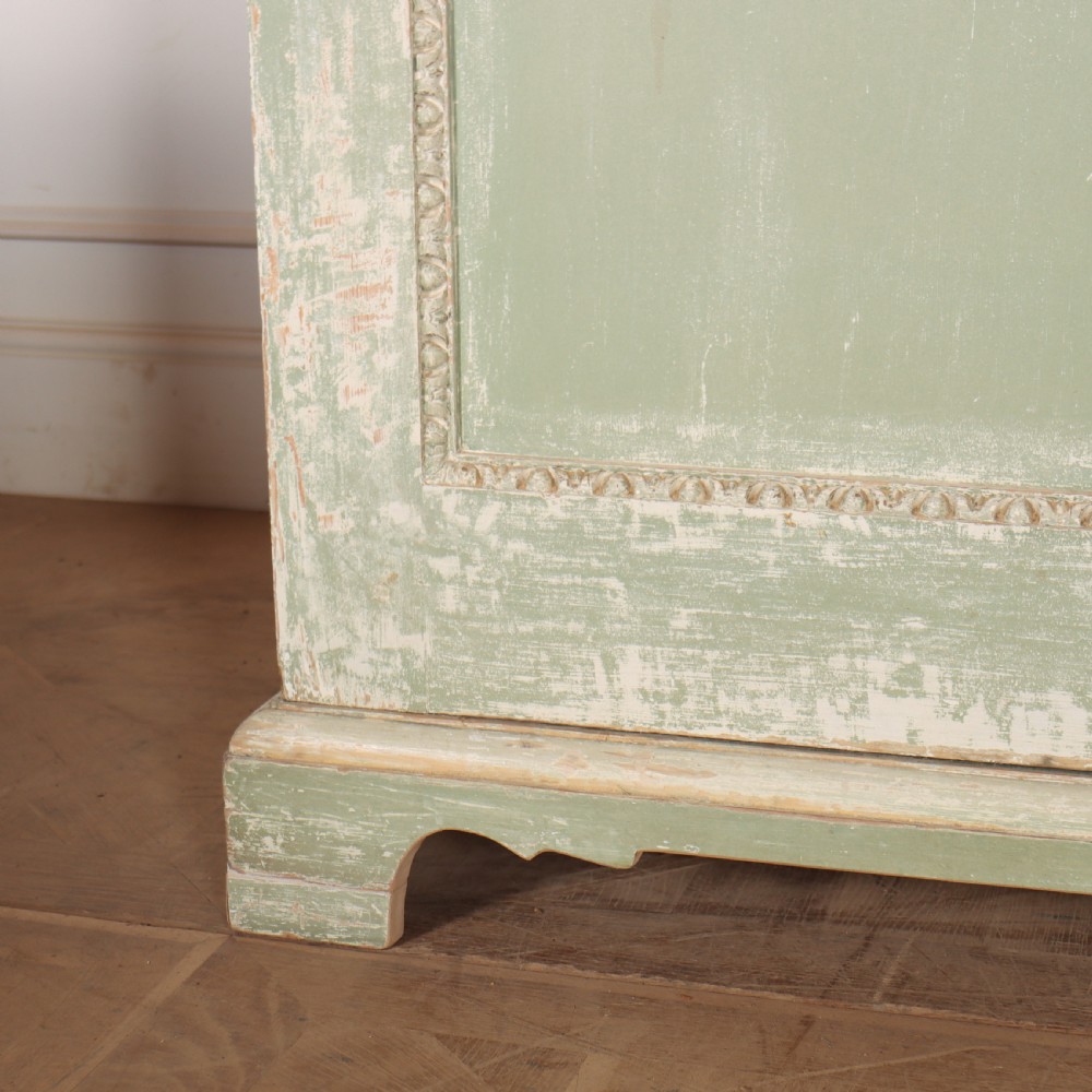 A 19th-century green painted wooden wardrobe featuring an arched carved cresting, double panelled doors, and a distressed finish. View VIII