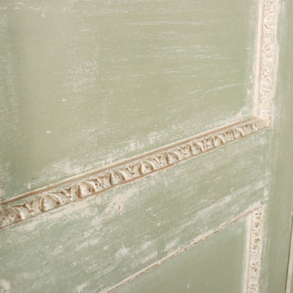 A 19th-century green painted wooden wardrobe featuring an arched carved cresting, double panelled doors, and a distressed finish. View XI