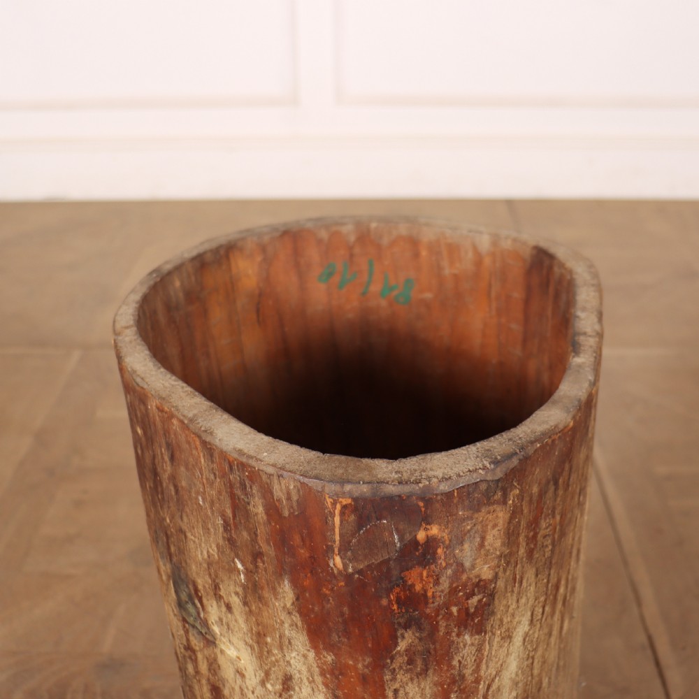 A cylindrical rustic vessel crafted from a hollowed-out tree trunk with weathered natural wood grain. View III
