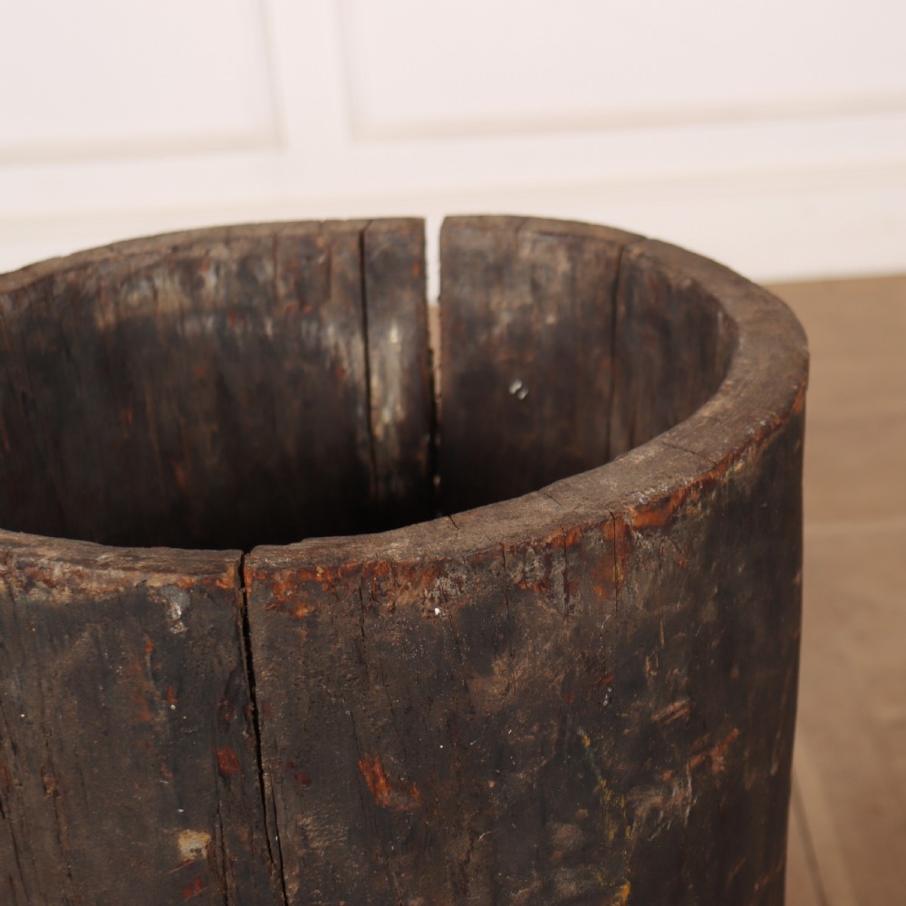 A vertical hollowed-out tree trunk displaying dark weathered timber with natural grain splits. View II