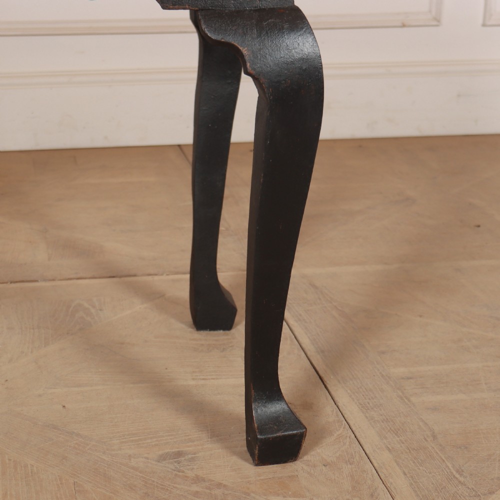A black painted antique lowboy table featuring three drawers with brass batwing handles, a shaped apron, and cabriole legs. View IV