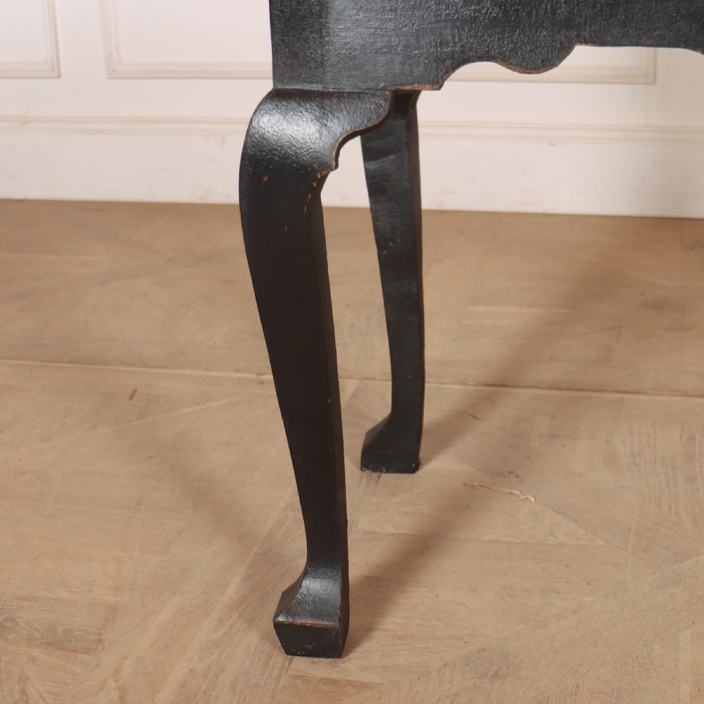A black painted antique lowboy table featuring three drawers with brass batwing handles, a shaped apron, and cabriole legs. View V