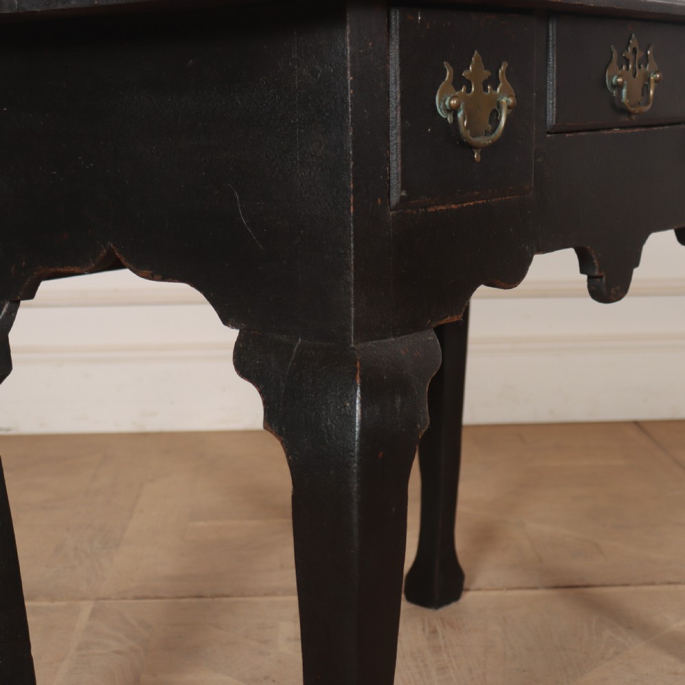 A black painted antique lowboy table featuring three drawers with brass batwing handles, a shaped apron, and cabriole legs. View VIII