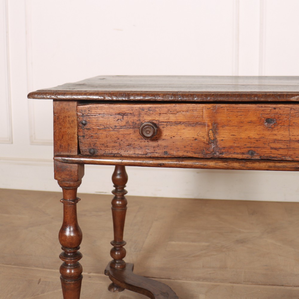 An 18th-century oak side table with a single frieze drawer, turned legs, wooden knobs, and a shaped lower stretcher. View II