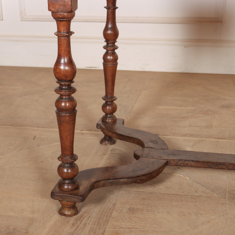 An 18th-century oak side table with a single frieze drawer, turned legs, wooden knobs, and a shaped lower stretcher. View III