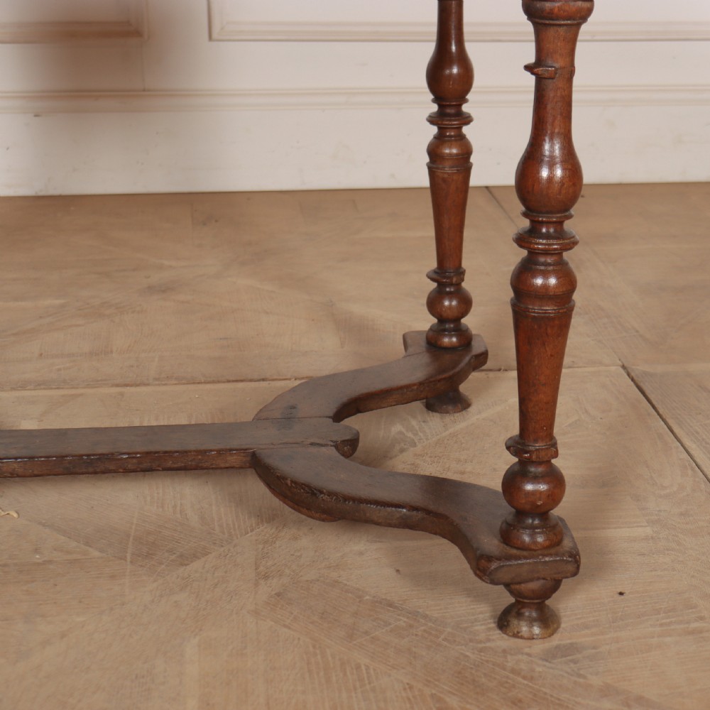 An 18th-century oak side table with a single frieze drawer, turned legs, wooden knobs, and a shaped lower stretcher. View IV