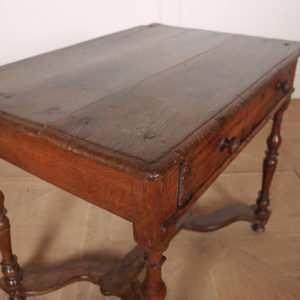An 18th-century oak side table with a single frieze drawer, turned legs, wooden knobs, and a shaped lower stretcher. View VII