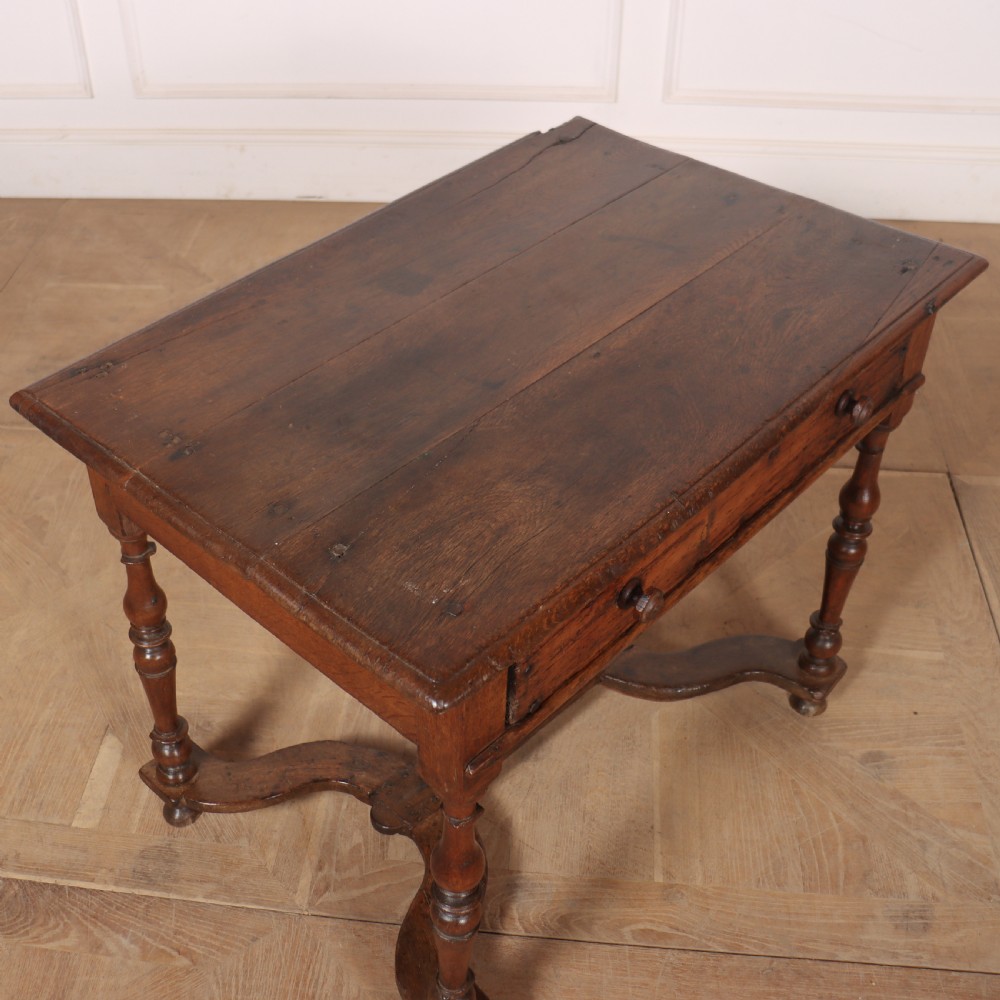 An 18th-century oak side table with a single frieze drawer, turned legs, wooden knobs, and a shaped lower stretcher. View VIII