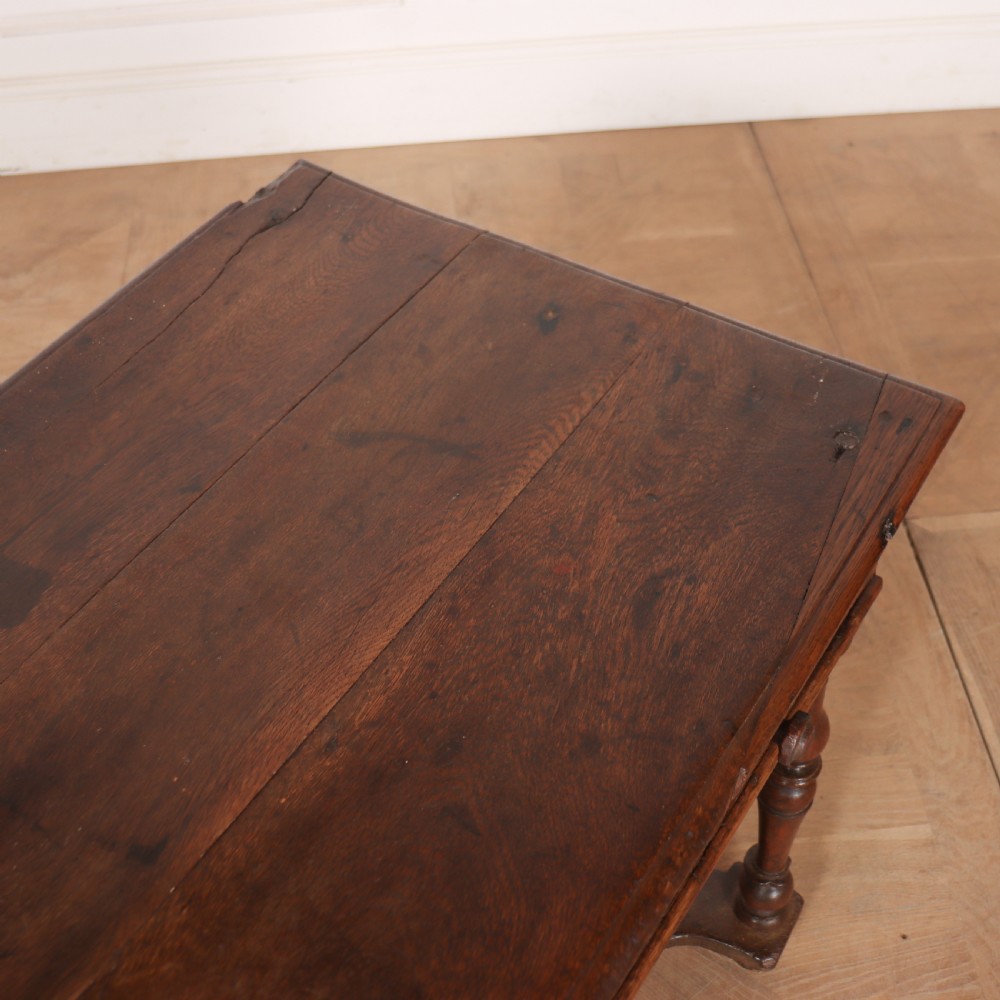 An 18th-century oak side table with a single frieze drawer, turned legs, wooden knobs, and a shaped lower stretcher. View IX