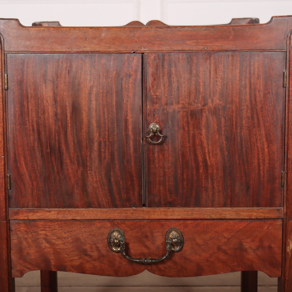 A Georgian mahogany tray-top bedside table featuring a double-door cupboard above a single drawer with a brass drop handle, supported by straight square legs. View III