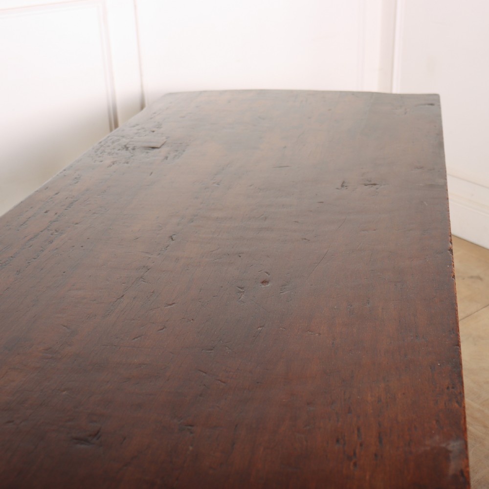 An antique dark walnut trestle table featuring turned baluster legs, carved scroll feet, and a turned central stretcher. View VII