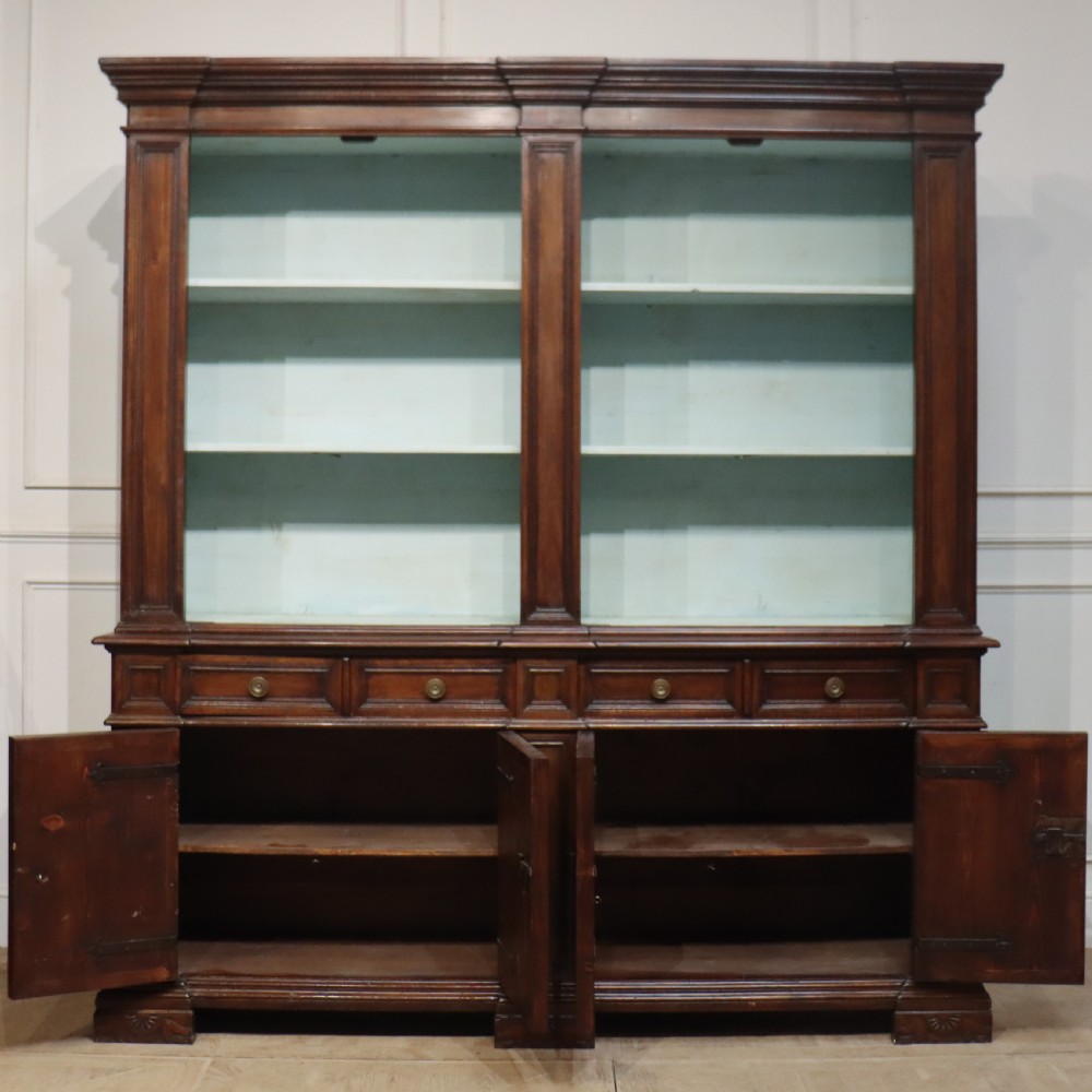 A large Italian dark walnut bookcase featuring four upper glass doors, four small drawers, and four fielded panel doors below. View X
