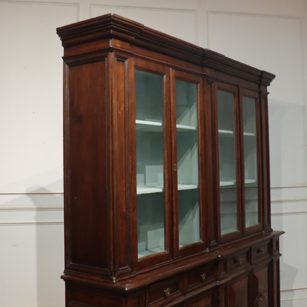 A large Italian dark walnut bookcase featuring four upper glass doors, four small drawers, and four fielded panel doors below. View XII