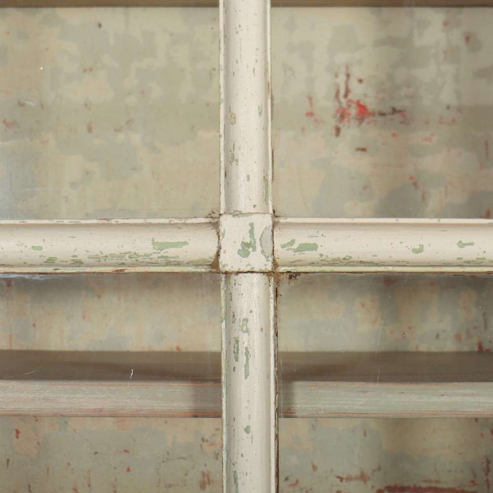 A tall Georgian painted bookcase featuring two multi-pane glazed doors above nine drawers with brass handles. View X