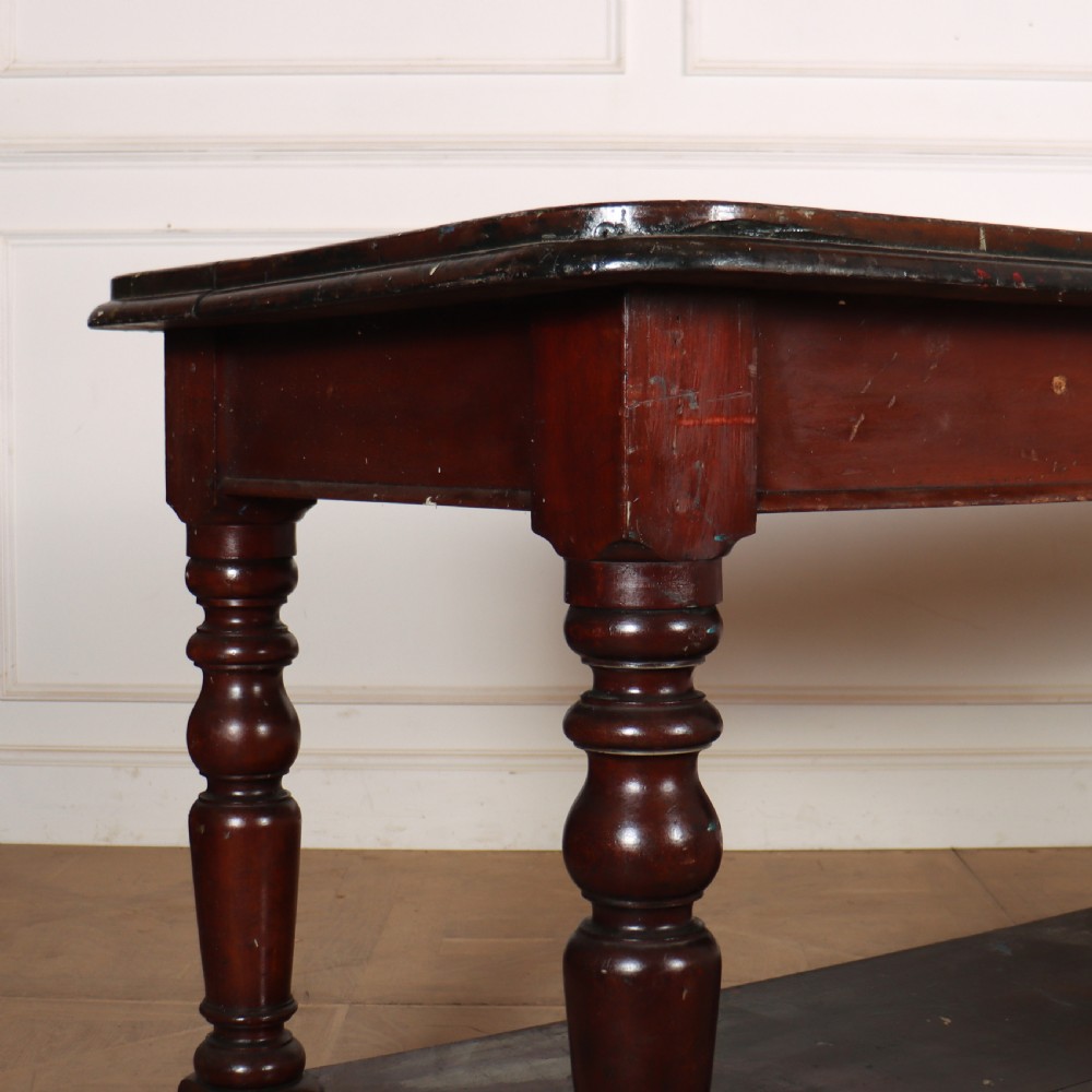 A long Victorian mahogany drapers table featuring turned legs and a low potboard shelf. View II