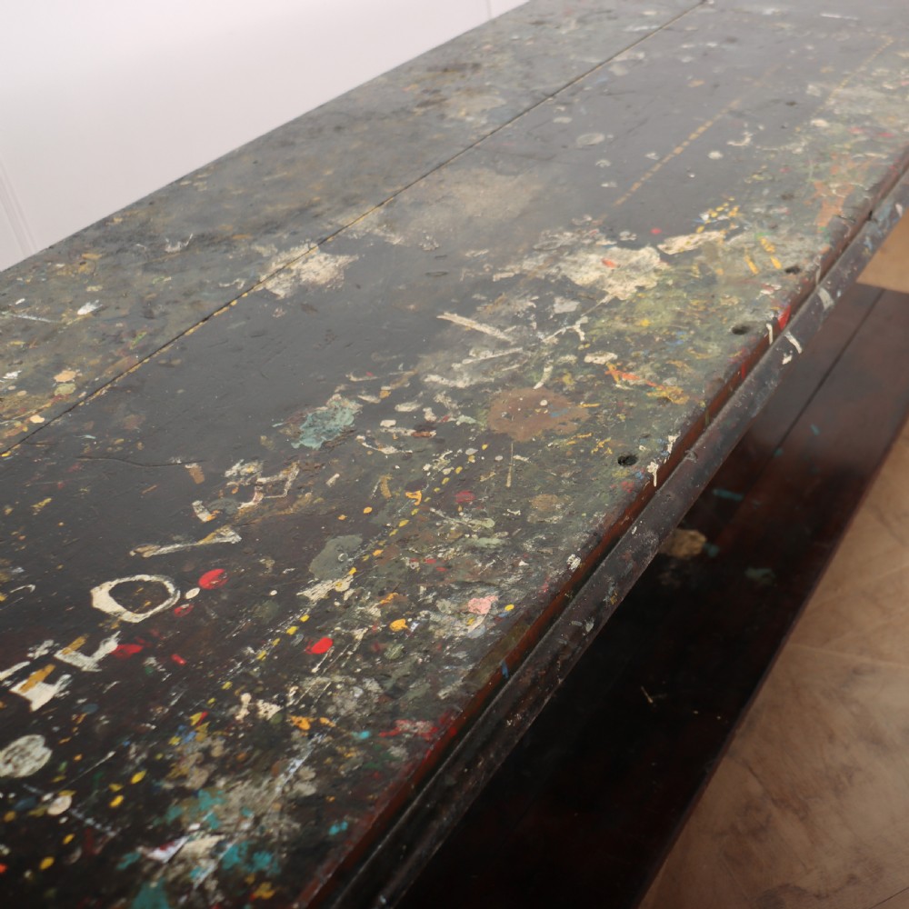 A long Victorian mahogany drapers table featuring turned legs and a low potboard shelf. View VII