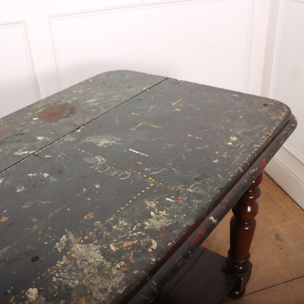 A long Victorian mahogany drapers table featuring turned legs and a low potboard shelf. View VIII