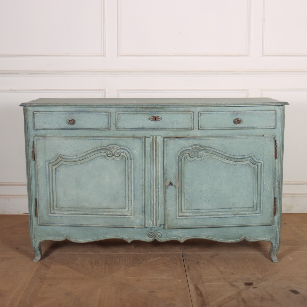 A 19th-century French provincial painted wooden buffet with three drawers above two carved panel doors in a distressed soft blue finish.