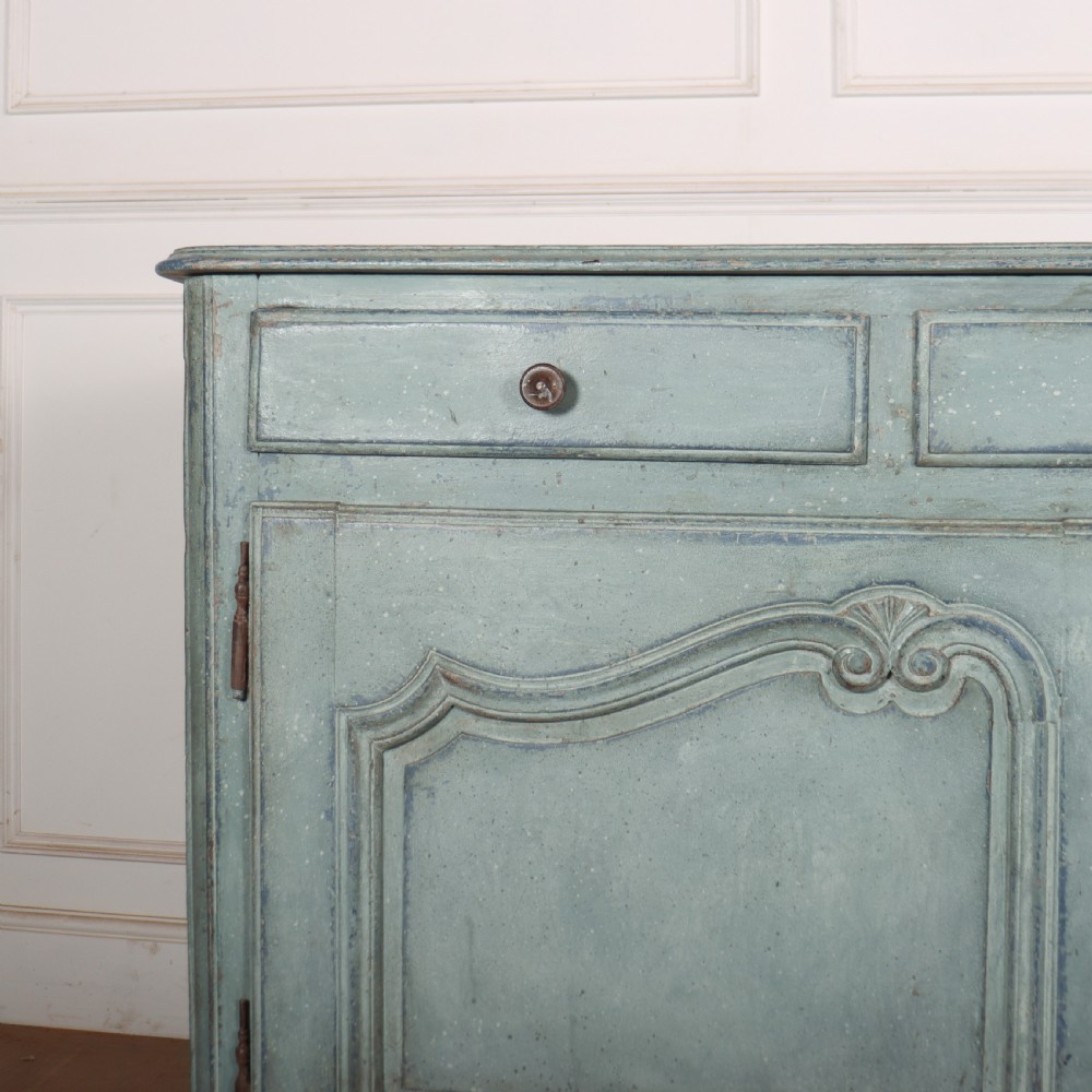 A 19th-century French provincial painted wooden buffet with three drawers above two carved panel doors in a distressed soft blue finish. View II