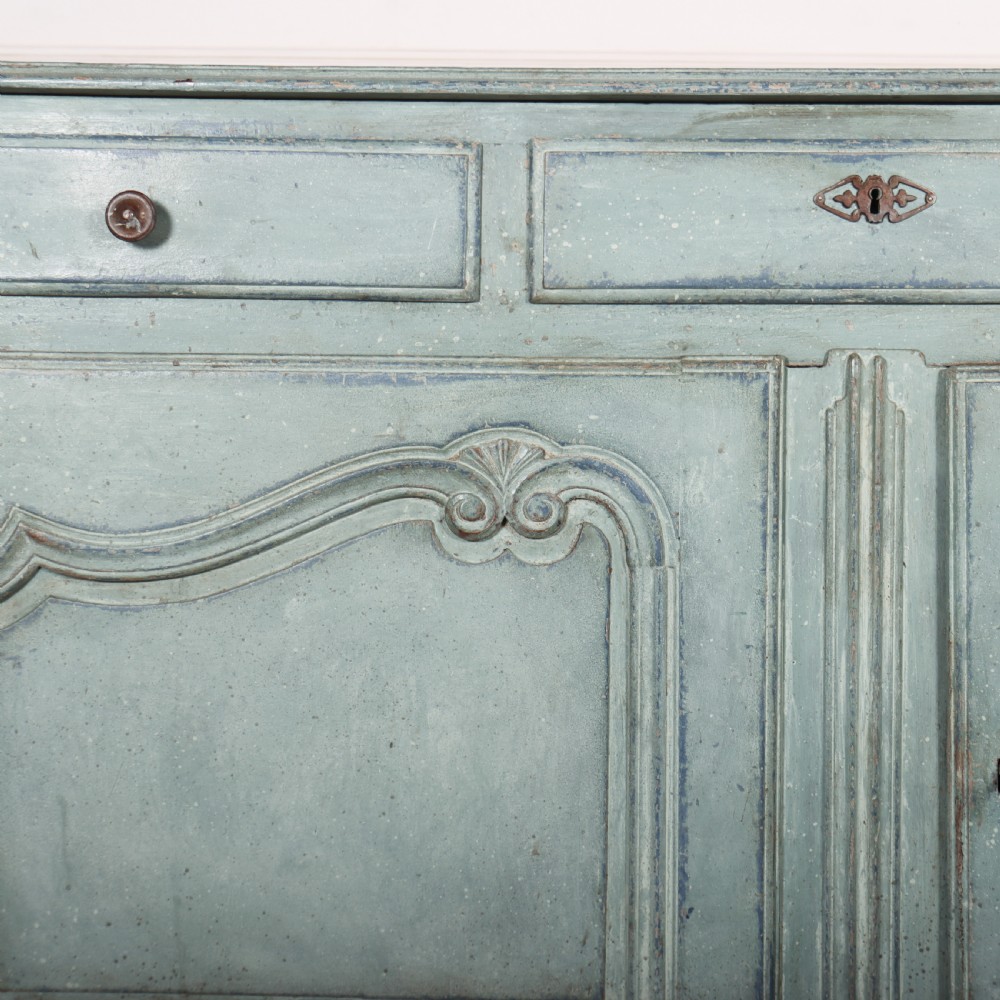A 19th-century French provincial painted wooden buffet with three drawers above two carved panel doors in a distressed soft blue finish. View IV