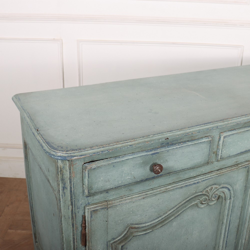 A 19th-century French provincial painted wooden buffet with three drawers above two carved panel doors in a distressed soft blue finish. View IX