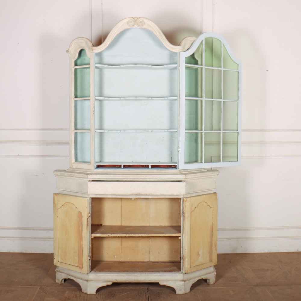 An 18th-century Dutch painted vitrine cabinet featuring an arched glass upper display section with green shelves over a double-door lower storage cupboard. View V