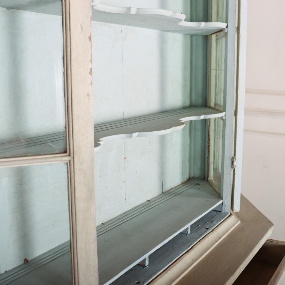 An 18th-century Dutch painted vitrine cabinet featuring an arched glass upper display section with green shelves over a double-door lower storage cupboard. View VI