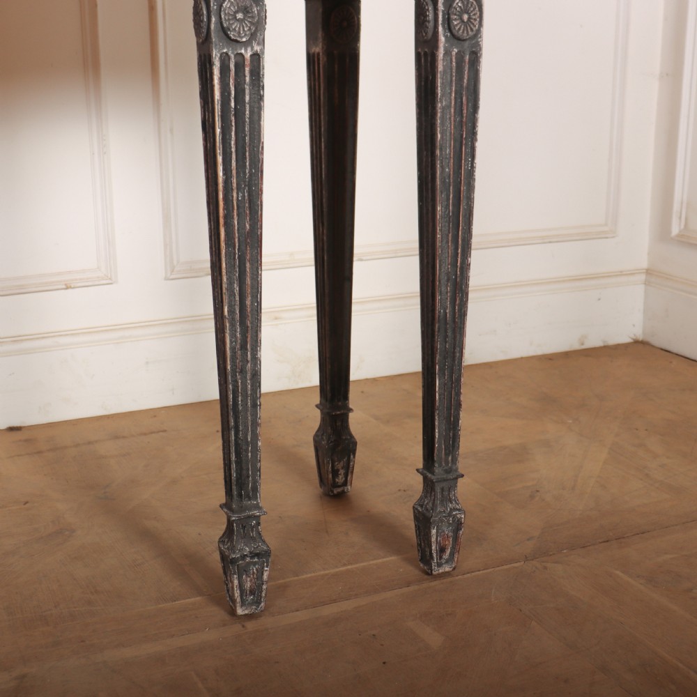 A Neoclassical dark grey painted console table with a marble top, featuring carved garland festoons and fluted tapered legs. View VII