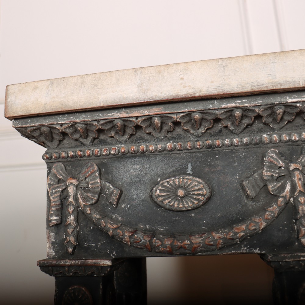 A Neoclassical dark grey painted console table with a marble top, featuring carved garland festoons and fluted tapered legs. View X