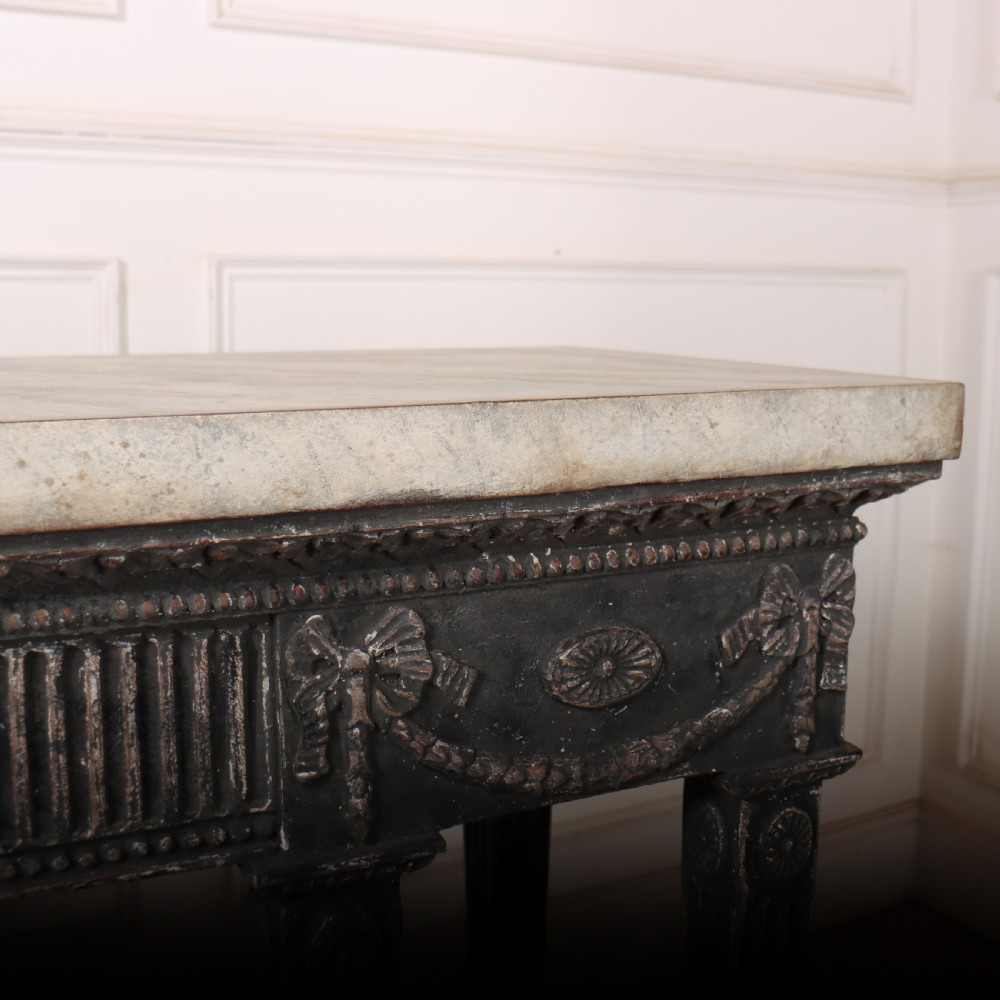 A Neoclassical dark grey painted console table with a marble top, featuring carved garland festoons and fluted tapered legs. View XI