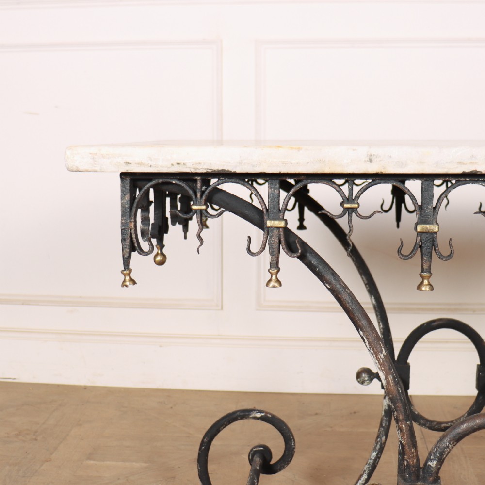 A 19th-century French patisserie table featuring a light marble top mounted on a dark wrought iron scrolled base with brass details. View II